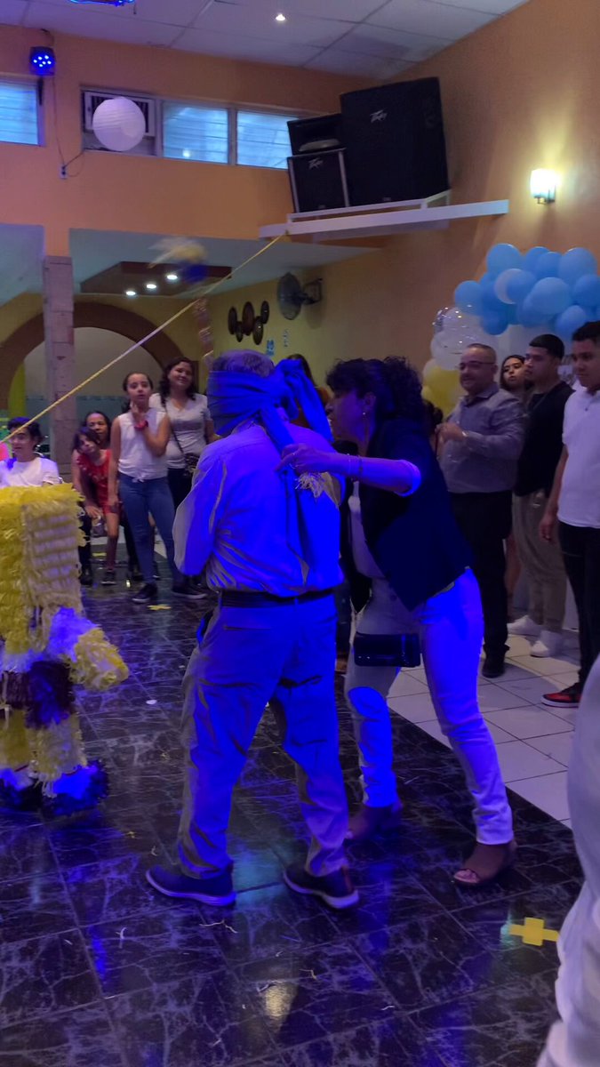 The image depicts a group of people enjoying an event with a piñata, likely at a birthday celebration or party. One woman is seen hugging another person as they both attempt to break open the pinata using a stick. The room has purple and blue colors which create a festive atmosphere. The post accompanying this photo promotes the Piñatata contest for a chance to win $1,000 USDT in return for participating and successfully breaking the piñata. The caption explains that the rewards are inside the piñata and encourages users to take part in the contest by sharing or reposting the image on social media with the caption "finally, you can smash things and get rewarded! my fav @voicehavefun just dropped the Piñata #contest #piñatare".