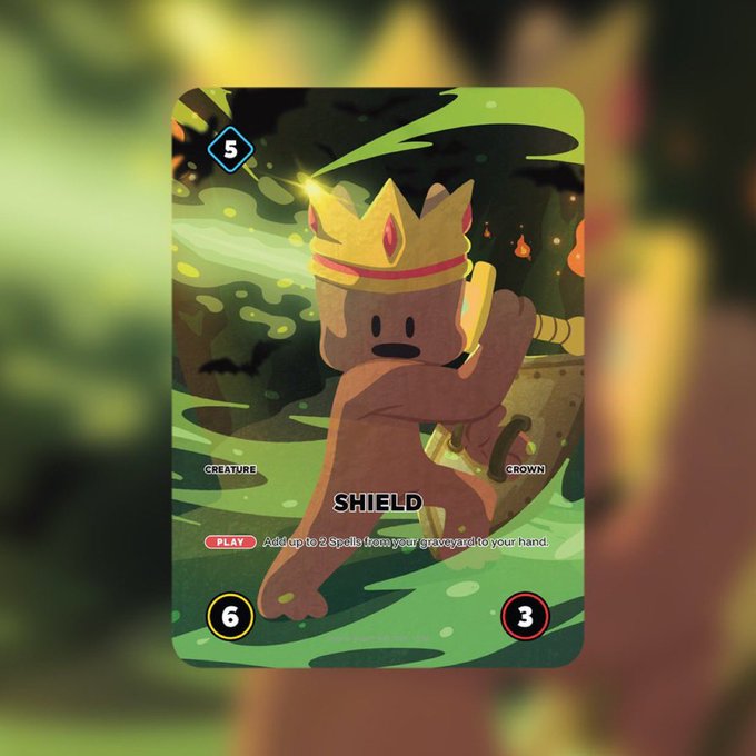 A trading card titled 'SHIELD' features a brown creature wearing a gold crown and holding a sword, with the text 'CREATURE' and 'CROWN', a cost of 5, attack 6, and defense 3.