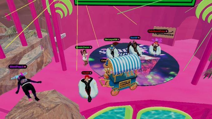 Screenshot of a vibrant 3D virtual world scene with avatars like 'ShendPeace3', 'Maverickqueen1', and 'DenniganOJK' gathered around a carnival cart.