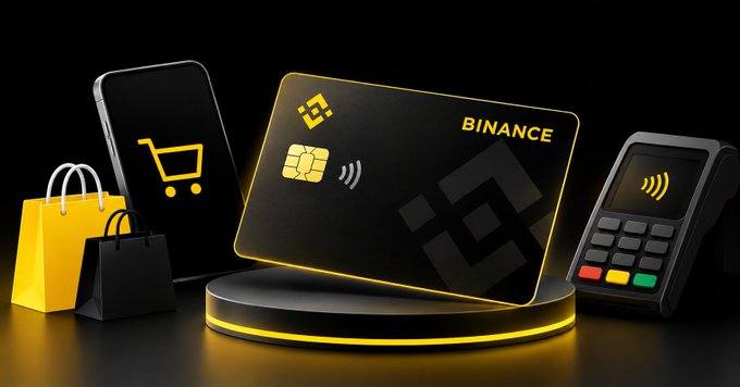 A 3D-rendered promotional image showing a Binance cryptocurrency card alongside a smartphone with a shopping cart icon, shopping bags, and a payment terminal, all in a yellow and black color scheme.