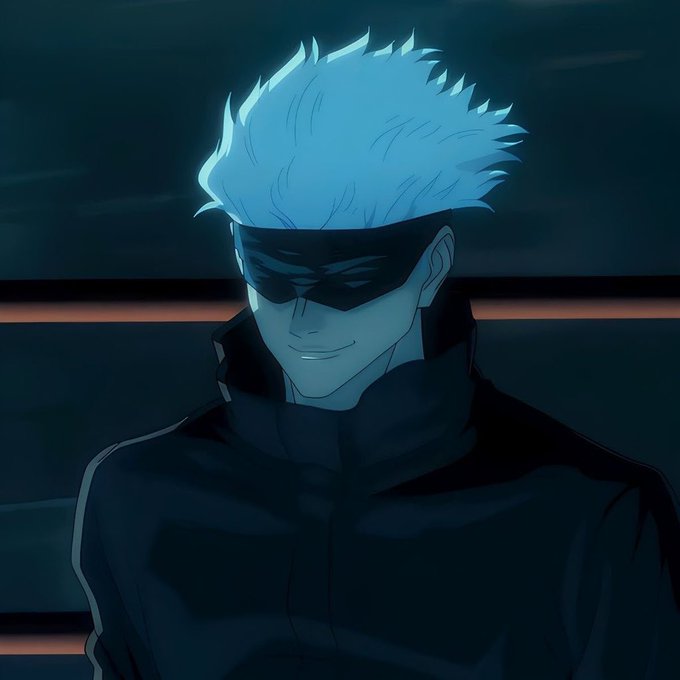 An anime-style character with spiky white hair, a black eye mask, and a dark high-collared jacket, smiling in a dimly lit setting.