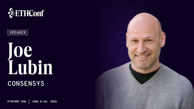 The image features a man wearing a gray sweater, standing against a purple background with white text that reads "Ethereum is taking over NYC @ethConf on June 8th to discuss the future of onchain finance". The man appears to be smiling for the camera and has his head tilted slightly to the left.