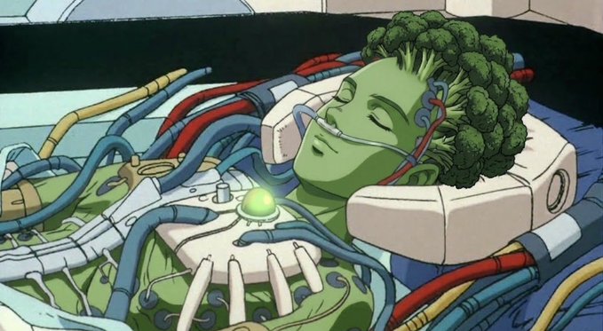 Anime art of a green-skinned character with broccoli for hair, appearing to be in a sci-fi medical or life-support pod with tubes and wires connected to her.