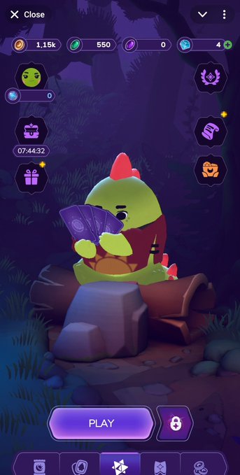 A mobile game screen showing a cute green dinosaur-like creature holding purple cards, with currency counters (1.15k, 550, 0, 4) and a purple 'PLAY' button at the bottom.