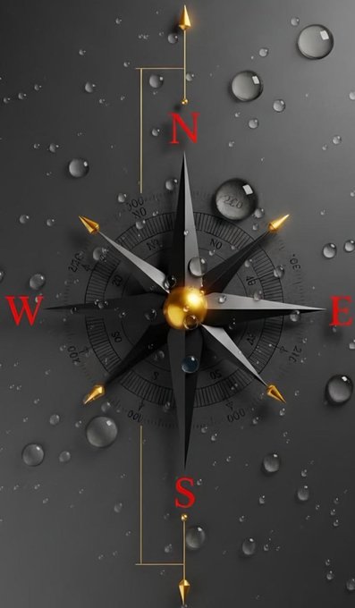 A decorative black compass rose with red letters marking N, S, E, and W cardinal directions, surrounded by water droplets on a dark background.