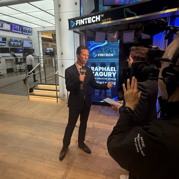 A man in a dark suit is being interviewed by a cameraperson on the floor of the New York Stock Exchange (NYSE) in front of a Fintech TV banner, ready to discuss Twenty One and bitcoin. Visible text includes "FINTECH TV," "RAPHAEL PAGURY," and "NYSE / INTERSECTION."