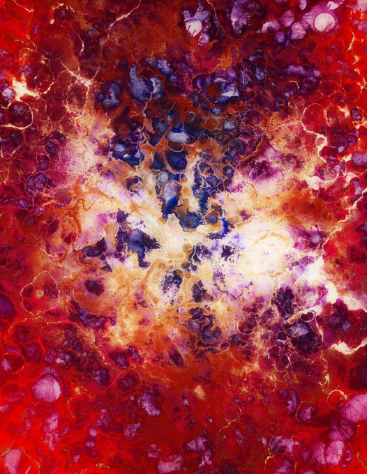An abstract, highly saturated image featuring red, purple, and yellow patterns that resemble alcohol ink art or a fiery, cosmic texture.