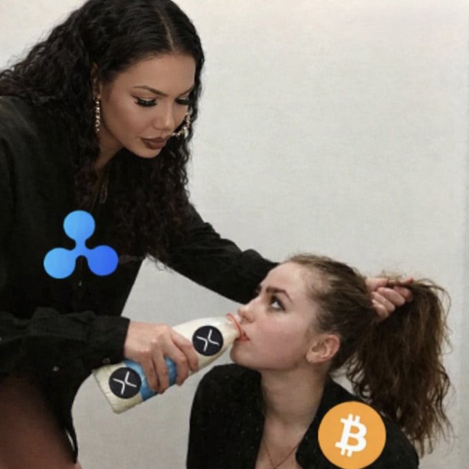 The image shows a woman force-feeding another woman a bottle labeled "X" (representing XRP), while a Bitcoin (₿) logo appears on the smaller woman's chest. This visual metaphor humorously illustrates the post's message that XRP is being "force-fed" or imposed as superior to Bitcoin, supporting the claim that "$XRP is what BTC wishes it could be" and "XRP >>> BTC."