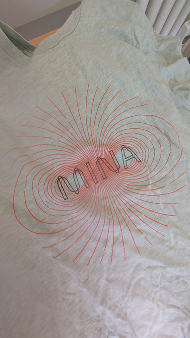 The image shows a white t-shirt with red lines, which appears to be a graphic design featuring the word "Mesa" written in black letters. The text is positioned centrally on the shirt, making it stand out against the light gray background. The caption below the image reads "#Mesa upgrade is go!! Any @MinaProtocol og' s remember this?".