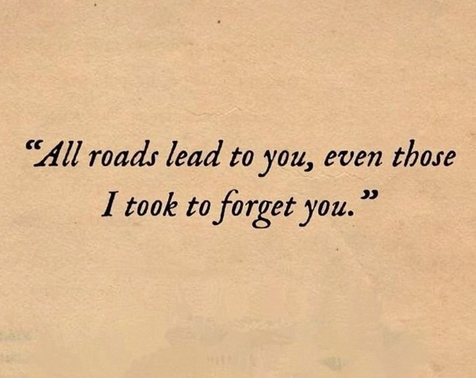 A typewriter-style quote on beige paper reading 'All roads lead to you, even those I took to forget you.'