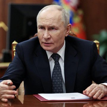 The image shows an older gentleman in a suit sitting at a desk, the setting suggesting a formal or government-related environment. Given the attire and decor, it's plausible to deduce that he is a high-ranking official or politician. The text accompanying the image mentions Russia's decision to embrace and facilitate the trading of cryptocurrencies like Bitcoin, Ethereum, and USDT on public exchanges, signaling a significant move towards integrating digital currencies into mainstream finance. This could imply that the person in the image may be involved in the policy-making process regarding Russia's new stance on crypto, aligning with the message of progression and support for cryptocurrency adoption within the country.