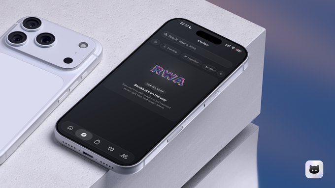 Two silver iPhones displayed on a textured white surface, one showing the back with its camera module and the other displaying an app screen titled 'RWA' with the text 'Stocks are on the way'.