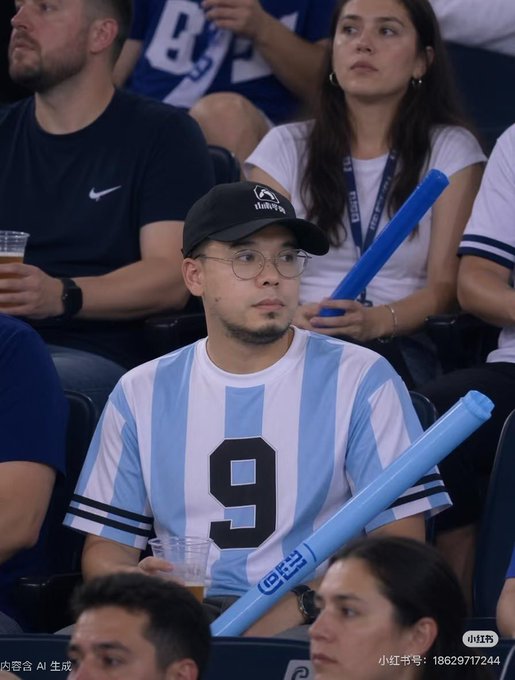 A young man wearing an Argentina soccer jersey with the number 9 and a "Rutgers" cap sits among a crowd, holding a blue inflatable cheering stick and a drink, seemingly watching a match.

The image appears unrelated to the Chinese text about Pepecoin and crypto investment—instead showing a fan at what looks like a sporting event, possibly a World Cup or international match given the Argentina jersey.