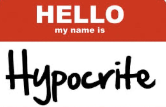 A classic red and white 'HELLO my name is' sticker with the word 'Hypocrite' handwritten in black marker.