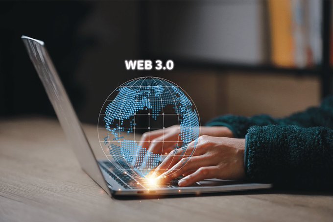 A photo of a person's hands typing on a laptop keyboard with a glowing 'WEB 3.0' digital globe hovering above the keys.
