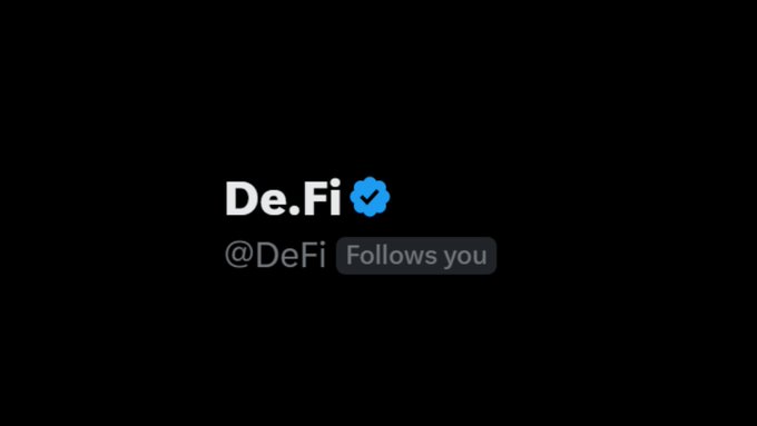 A screenshot of a Twitter/X notification showing "De.Fi @DeFi" with a blue verified checkmark and a "Follows you" badge. The image appears to be from a social media engagement post where the verified De.Fi account invited users to creatively explain DeFi in one sentence, with top answers receiving a follow.