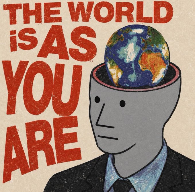 An illustrated poster featuring a gray-suited figure with an open head containing Earth, alongside the bold red text 'THE WORLD IS AS YOU ARE.'