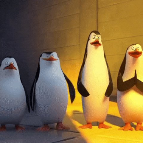 iced penguins stand on a yellow floor, with two smiling and one waving their arms.