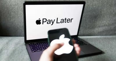 The image shows a person holding an iPhone next to a laptop computer that displays the Apple Pay app. The laptop screen also has the words "Pay Later" written on it, indicating that the device supports Apple Pay payments. This suggests that the user can conveniently pay for goods and services using their smartphone or laptop, potentially through various payment methods such as credit cards, PayPal, or even cryptocurrency.