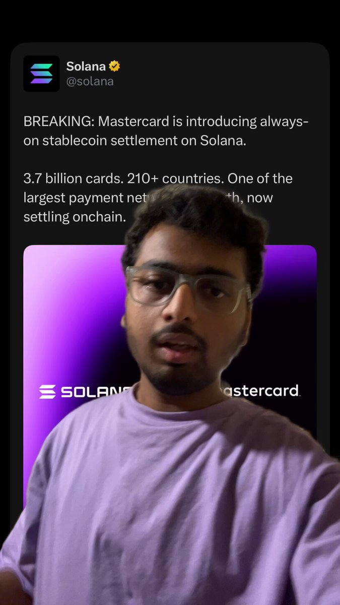 The image shows a man wearing glasses and a purple shirt with his face displayed on a smartphone screen. The background of the image is black, making him stand out against it. There are several lines of text visible in the image that include information about Mastercard's use of different cryptocurrencies such as solana, ethereum, and other chains. This post seems to be discussing the advantages or disadvantages of using these various digital currencies for payment purposes.