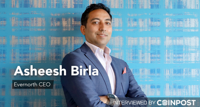 A promotional image showing Asheesh Birla, CEO of Evernorth, wearing a blue suit jacket against a blue patterned background, with text indicating he was interviewed by Coinpost.
