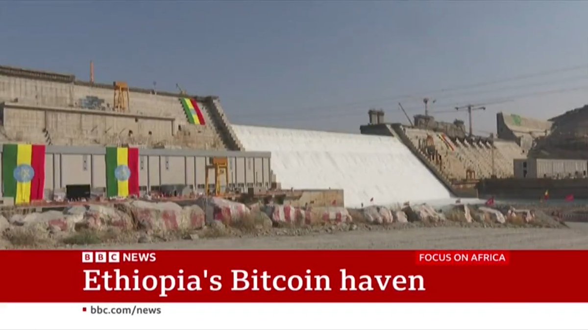 A BBC News screenshot shows a large hydroelectric dam with water cascading down its spillway, adorned with Ethiopian flags, under the headline "Ethiopia's Bitcoin haven" as part of the "Focus on Africa" segment, illustrating how the country's abundant hydropower resources are fueling its growing bitcoin mining industry.