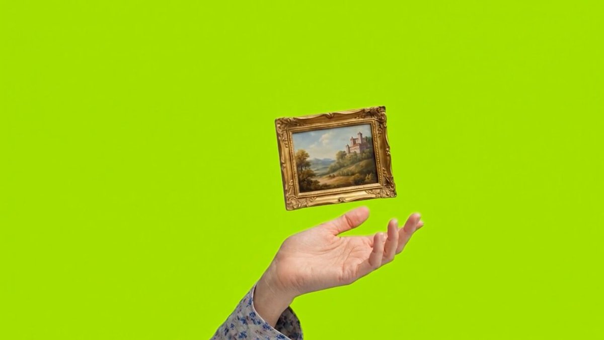 The image features an abstract painting of a landscape, which appears to be floating in midair above someone's hand. The painting is small enough that it can fit within the palm of the person holding it. The background color of the image is green, creating a contrast with the artwork and making it stand out even more. The post seems to be promoting an idea about the importance of having a purpose-built digital asset management system for real world assets.