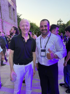 Two men smile and pose together at an outdoor evening event in Istanbul, with one giving a thumbs-up and wearing a "CIRCLE" lanyard badge. The image captures a networking moment with Circle CEO Jeremy Allaire, fitting the post's discussion about how USDC stablecoins are transforming the global payments industry.