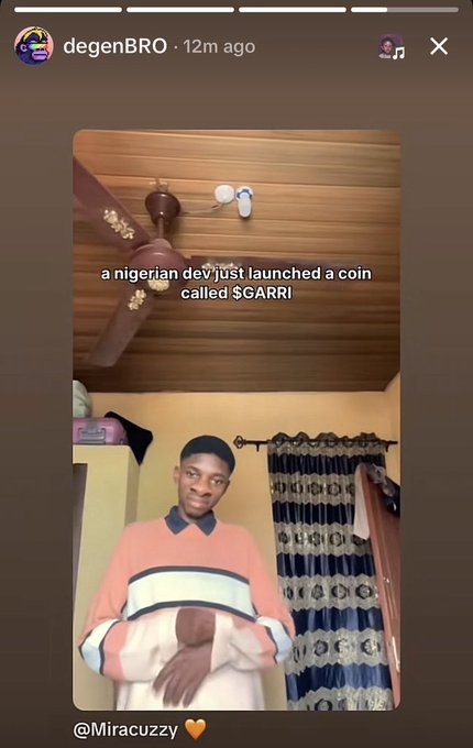 The image shows a young man in a pink, white, and navy striped sweater standing in a bedroom, with on-screen text reading "a nigerian dev just launched a coin called $GARRI," supporting the post's call to promote the $GARRI token on TikTok.