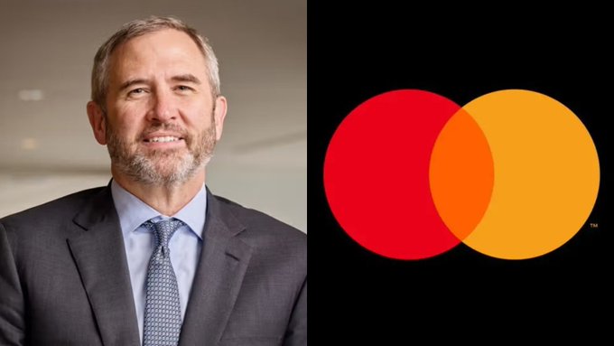 The image shows a smiling man in a suit and tie alongside the Mastercard logo, relating to the announcement that Mastercard has officially connected to a live U.S. Treasury settlement on the XRP Ledger, highlighting the payment giant's integration with blockchain-based financial infrastructure.