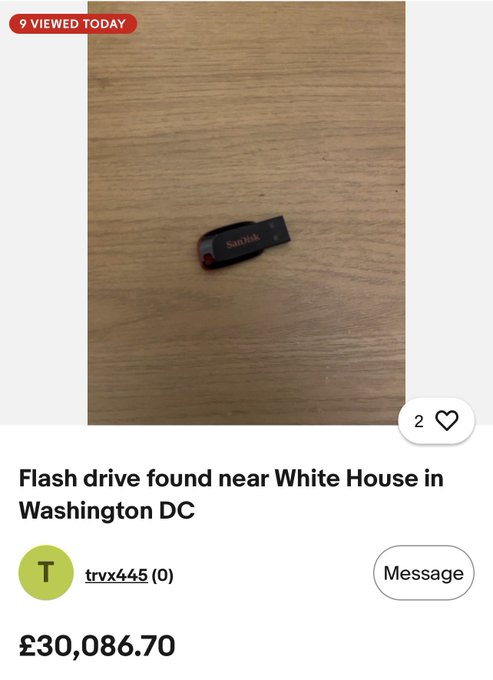The image shows a SanDisk flash drive lying on a wooden surface, listed on what appears to be eBay or a similar marketplace with the caption "Flash drive found near White House in Washington DC," priced at £30,086.70 with only 2 likes and 9 views today, while the accompanying post jokes about auctioning it alongside a suspicious-looking cryptocurrency contract address.