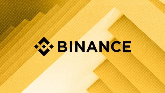 The image features a logo that reads "Binance" written in black letters against a yellow background. The text also includes the words "just in", "7,000+ U.S. stocks & ETFs", "with support for stablecoin-funded investing and plans for tokenized stocks on BNB Chain". This suggests that the image is related to the cryptocurrency market or financial news, possibly discussing the recent launch of a new trading platform by Binance or some other financial institution.