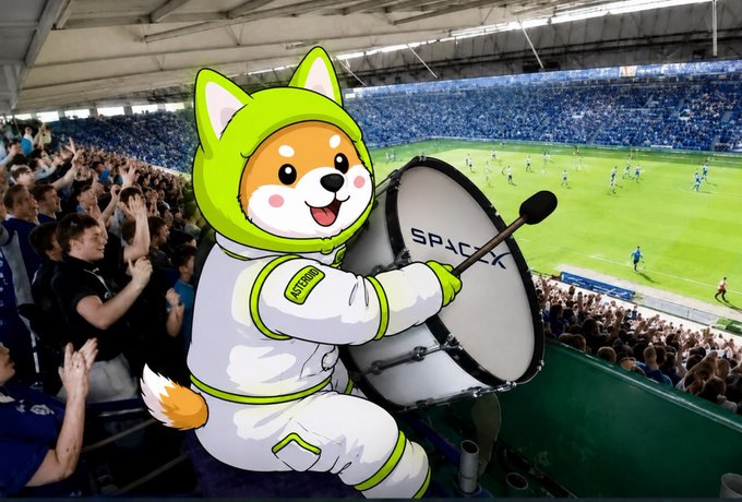 A Shiba Inu in an astronaut suit with "ASTERIOD" on its arm beats a drum with the "SPACEX" logo, watching a soccer game in a stadium. The image supports the post's theme of "ASTERIOD" controlling the countdown.