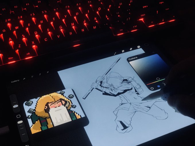 A person drawing anime-style artwork on a tablet with a stylus, illuminated by a red-backlit keyboard, with a reference image of a pixel art character visible on the tablet screen.