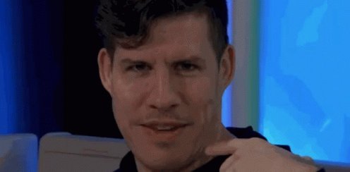 The image features a man with short hair wearing a black shirt, sitting next to a white wall or chair. He has his hand on his chin and appears to be looking at something off-camera. The caption reads "Hot take @quipnetwork feels much more infrastructure focused than narrative focused", which suggests that the focus of the image is on the man's facial expression rather than a narrative story.
