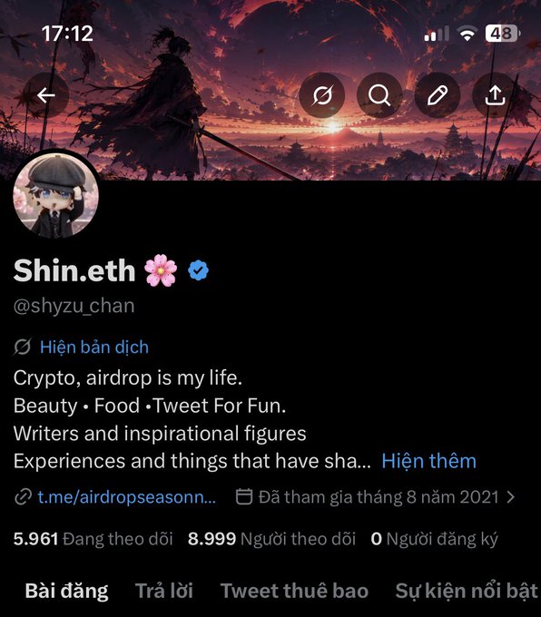 A Twitter profile screenshot for "Shin.eth" (@shyzu_chan) featuring a dark anime warrior banner, with the bio mentioning crypto/airdrop interests, 5,961 following, 8,999 followers, and a note about being a "Hiện bản dịch" (verified translation account). The accompanying post humorously clarifies that the user is the same person who just changed their name from "Shyzu" to "Shin" after getting over admiring Vitalik, and jokes that despite being male, followers keep calling them "chị" (sister).