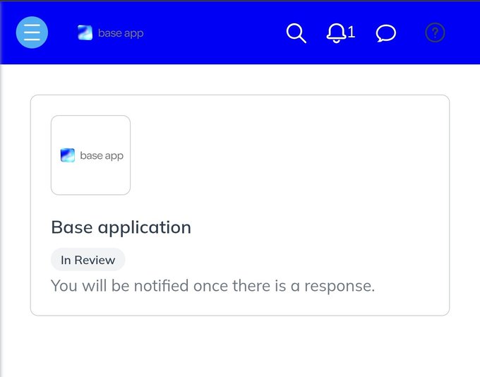 The image shows a computer screen displaying a message box with a blue background, white text, and an application icon. The message reads "Base Application In Review You will be notified once there is a response." This indicates that someone has recently applied for the Base App and the system is in the process of reviewing their application.