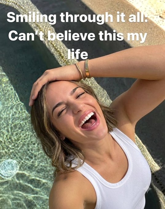 A woman with a wide smile laughs by a pool, with text over the image saying "Smiling through it all: Can't believe this my life." This image reflects the optimistic tone of the post, suggesting a positive outlook despite any market challenges as "onchain summer" begins.