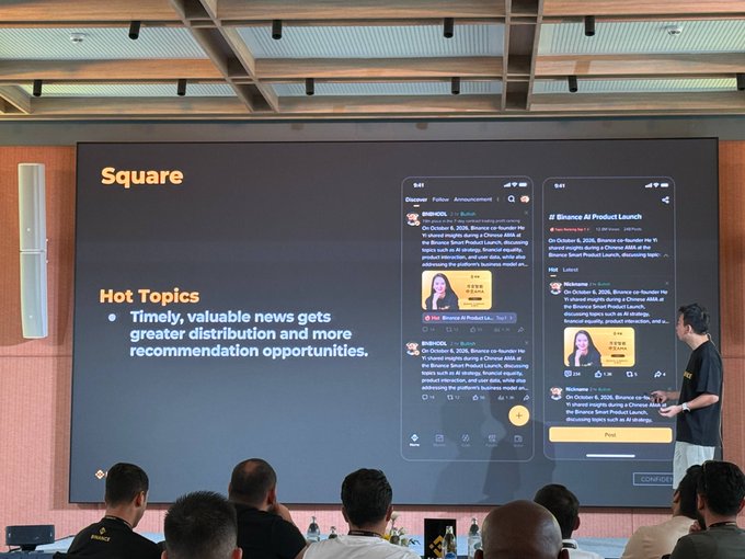A presenter showcases Binance's "Hot Topics" feature on a large screen during a masterclass, displaying how the AI tool aggregates news like "Binance AI Product Launch" to enhance distribution and recommendations for users.