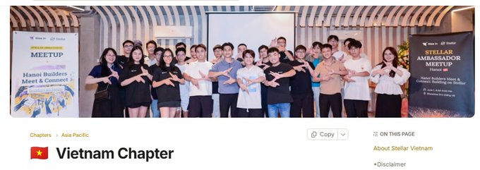 A group photo from a Stellar Ambassador Meetup held in Hanoi, Vietnam, with attendees making a gesture in front of Stellar and Meetup banners, with a label 'Vietnam Chapter' below.