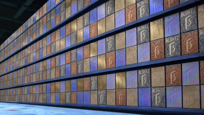 A wall is covered in colorful metallic square panels featuring a 'B' logo and the text 'BLOKYZ'.