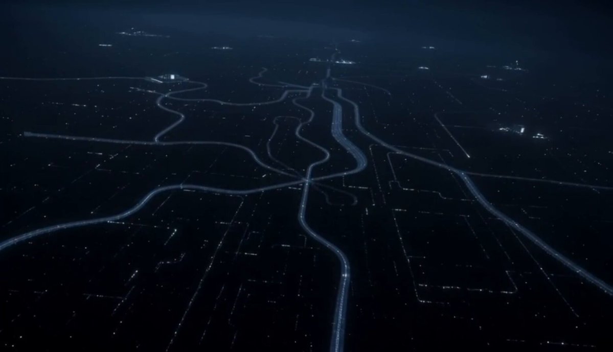The image shows an aerial view of a city with numerous roads and highways crisscrossing through it. The roads appear dark, suggesting that they may be at night or under low light conditions. The city's layout seems complex, with many streets and intersections. The image does not provide any specific information about the content of the post or its relation to AxiosFi.
