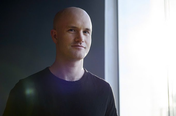 The image features a bald man wearing a black shirt, standing next to a window with sunlight coming through it. The man appears to be looking off into the distance or deep thoughtfully. The background of the photo has a dark color, which contrasts with the bright sunlight streaming in from the window. There is also a text overlay that reads "When the most powerful banker in the world says “we will fight it” , implying a sense of determination and resilience. This could be related to the post about RippleXrpie or cryptocurrency, as they both involve overcoming challenges and adapting to new technologies.