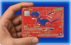 A hand holds up a red Pokémon trading card featuring a blue creature with claw markings, displayed against a blue background.