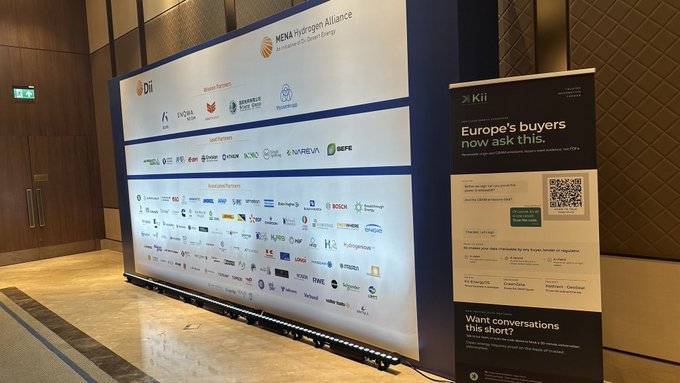 A sponsor and partner wall at the Dii Desert Energy summit in Istanbul displays logos for MENA Hydrogen Alliance, IVGLA, Apex Brasil, KPMG, HPE, and numerous other companies, alongside a Kii banner inviting attendees to connect with "Europe's buyers." The image visually represents the setting where the KaspaKii representative demonstrated applications built on the Kaspa ($KAS) blockchain during the event.