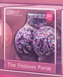 A box for 'Pop Mart' features a vase filled with colorful beads and pink packaging labeled 'The Poolown Parts'.