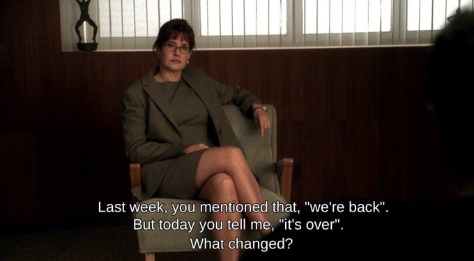 A woman in a green suit and glasses sits in a chair, asking, "Last week, you mentioned that, 'we're back'. But today you tell me, 'it's over'. What changed?" The caption wryly captures the whiplash of conflicting market narratives—buying on "it's over" and selling on "we're back"—that the post suggests can make or break investors this year.
