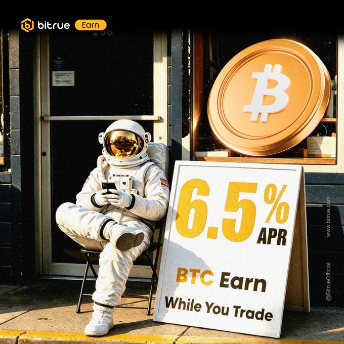 An astronaut sits outside a storefront beneath a large Bitcoin logo, beside a sign advertising "6.5% APR BTC Earn While You Trade," visually promoting Bitrue's promotional Bitcoin earn campaign offering 6.5% APR.
