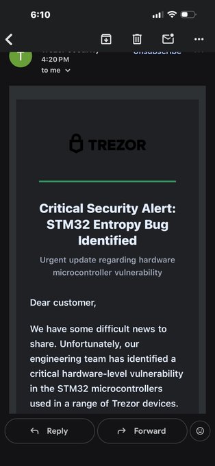 A smartphone screenshot of an email titled "Critical Security Alert: STM32 Entropy Bug Identified" from TREZOR, addressing customers about an urgent hardware microcontroller vulnerability update.