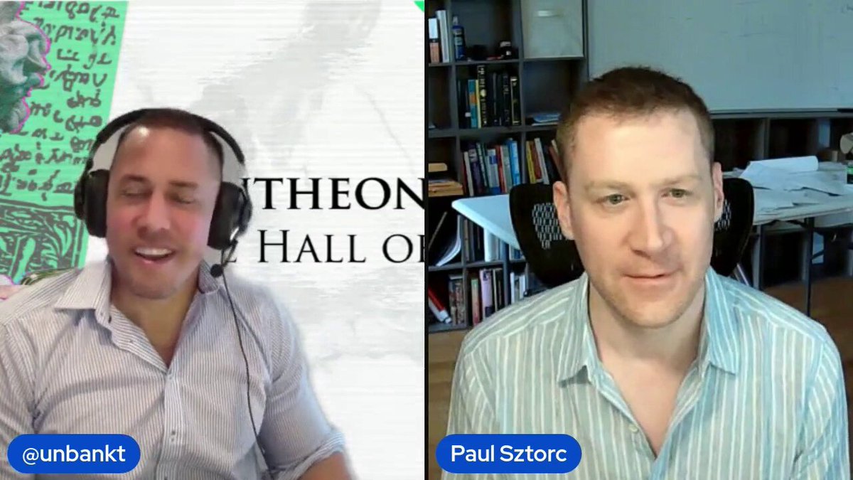 The image shows two men wearing headphones sitting next to each other with their faces displayed on a computer screen. The background of the image features a white wall with a green sign that reads "Theon Hall of Fame", suggesting they are participating in an online interview or discussion related to Bitcoin and cryptocurrency. One man is wearing a blue striped shirt, while the other has a green one. They appear to be engaged in a conversation about Bitcoin's potential impact on the market.